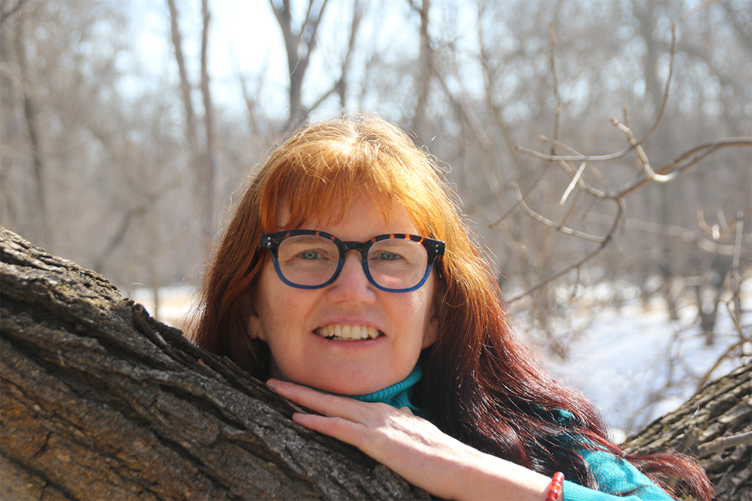 Shirley Thompson resting on a tree branch.